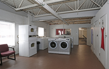 A laundry room with washers and dryers.